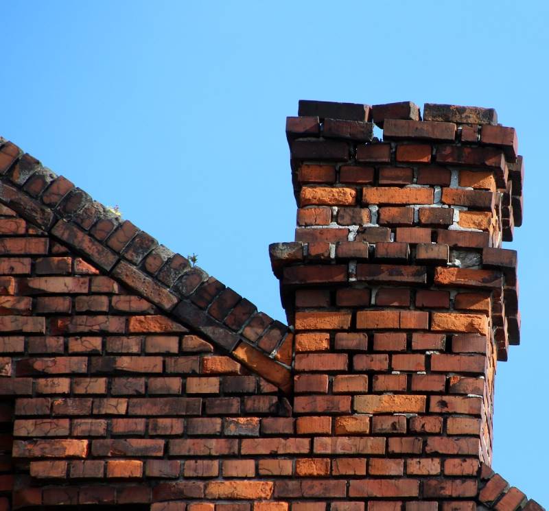Damaged chimney on an Foothill Ranch home showing cracks and missing mortar